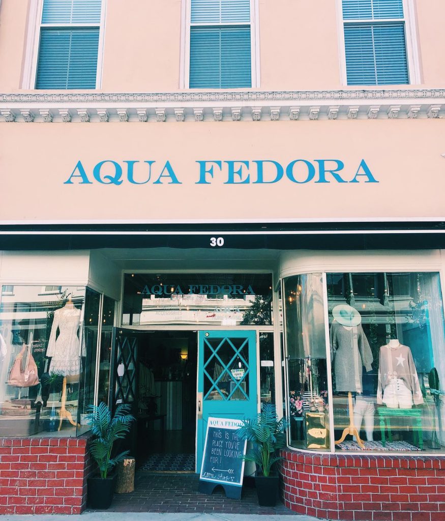 storefront display window of Aqua Fedora in Downtown Wilmington