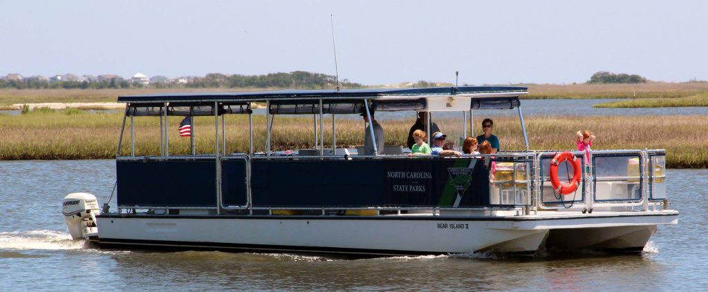 A ferry from Hammocks Beach State Park floats in the water