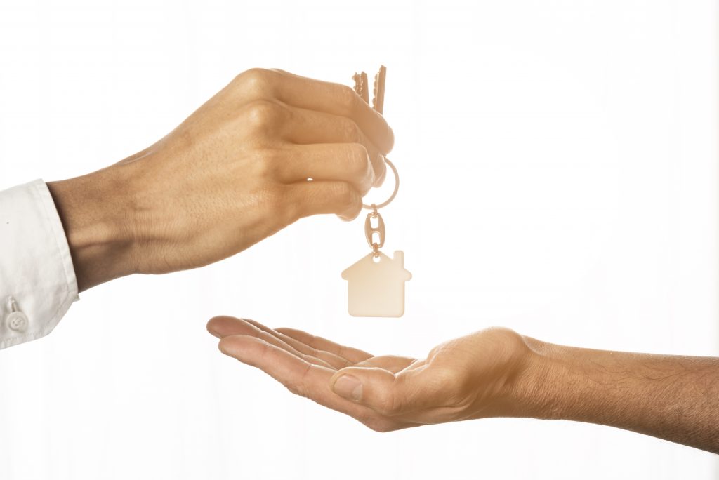 June Market Update: Arth Real Estate | Image of person handing house key to someone