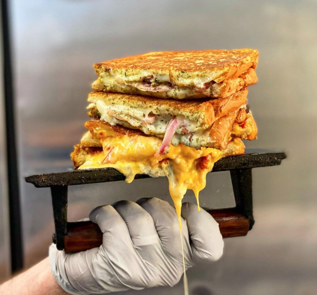 A grilled cheese coming off the griddle at Cheese Smith. 